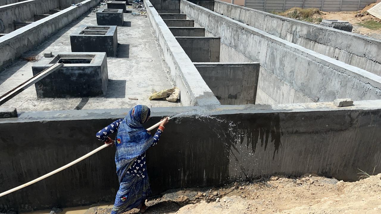Foundation walls and plinth beams being cured with water